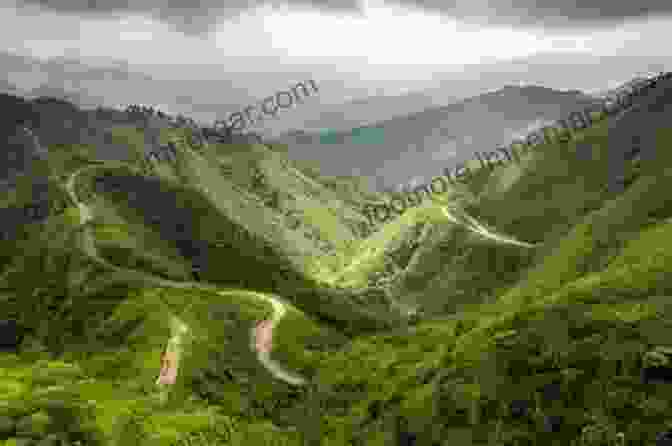 Aerial View Of A Winding Mountain Road Surrounded By Lush Greenery And Towering Peaks. The Alps Jackie Speicher